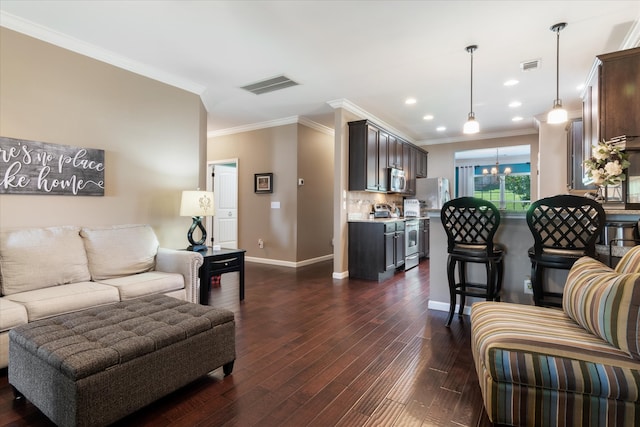 living room with ornamental molding and dark hardwood / wood-style floors