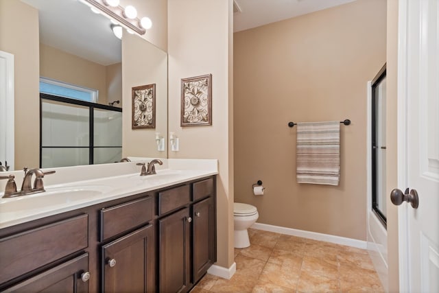 full bathroom with toilet, dual bowl vanity, tile flooring, and combined bath / shower with glass door