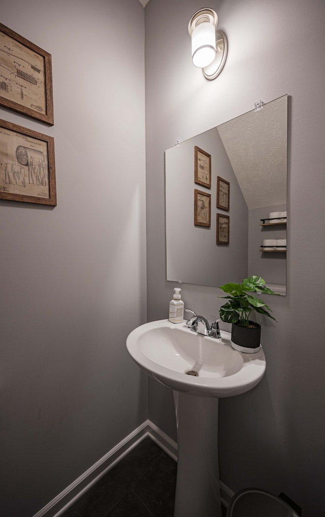 bathroom featuring tile floors and vaulted ceiling