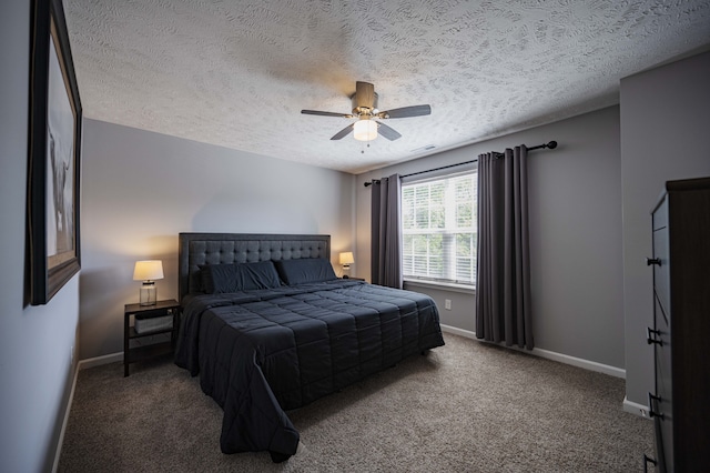 carpeted bedroom with ceiling fan and a textured ceiling