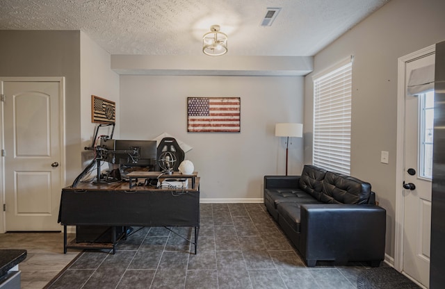 home office featuring a textured ceiling