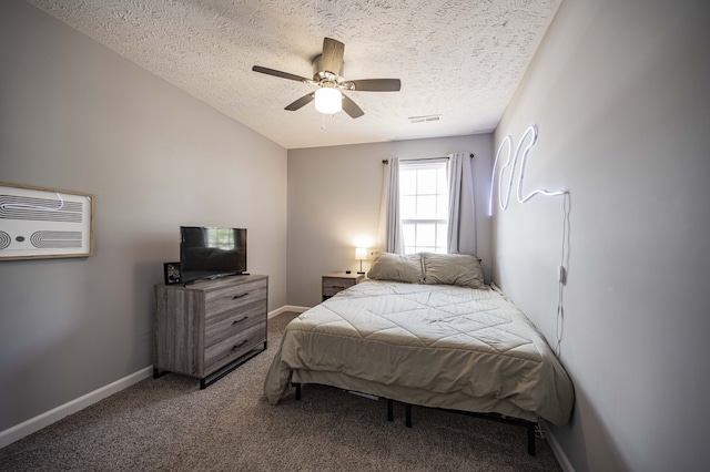 carpeted bedroom featuring ceiling fan, a textured ceiling, and a wall unit AC