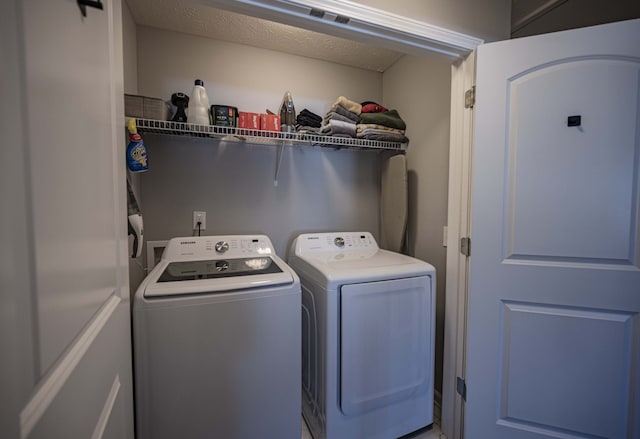 washroom with washer and dryer