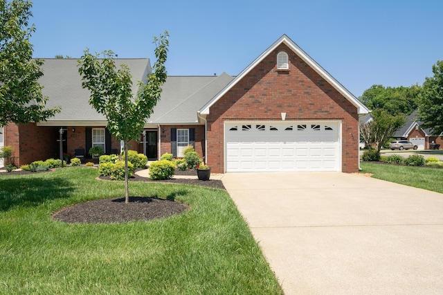 view of front of property featuring a front yard and a garage