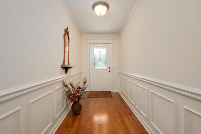 doorway featuring dark hardwood / wood-style flooring and crown molding