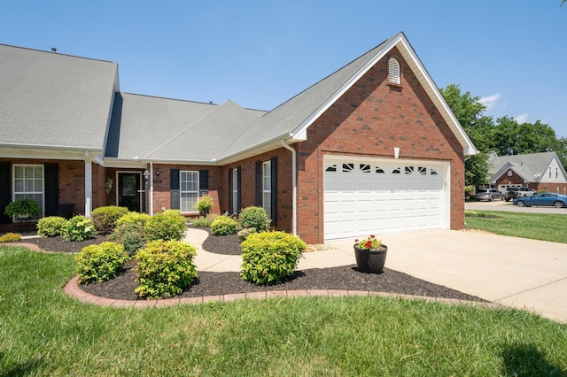 view of front of home with a front lawn and a garage