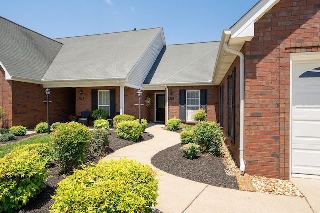 view of front of property featuring covered porch and a garage