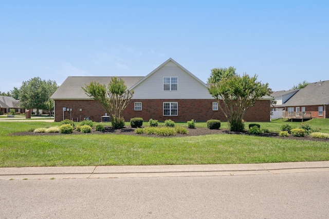 view of front of house with a front yard and a deck