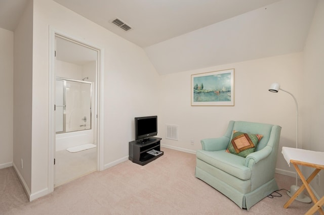 living area featuring light colored carpet and vaulted ceiling