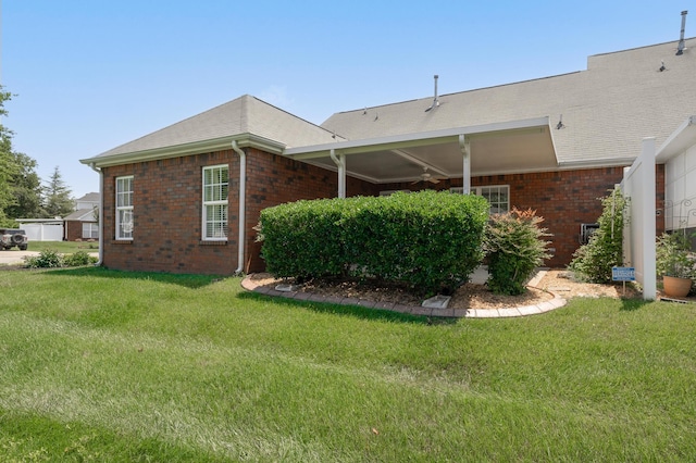 view of side of property with a lawn