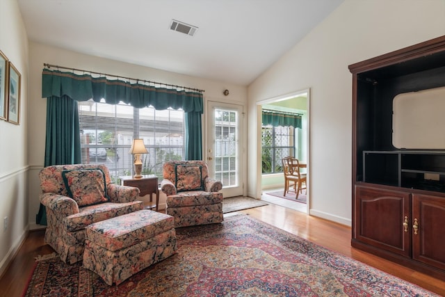 living area with light hardwood / wood-style floors and lofted ceiling