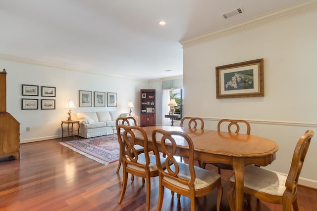 dining space featuring crown molding and dark hardwood / wood-style floors