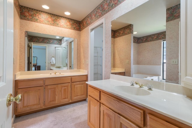 bathroom with vanity and a tub