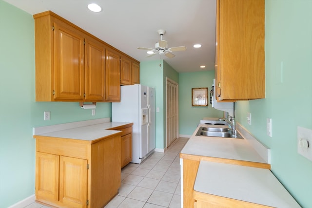 kitchen with ceiling fan, white fridge with ice dispenser, sink, and light tile floors