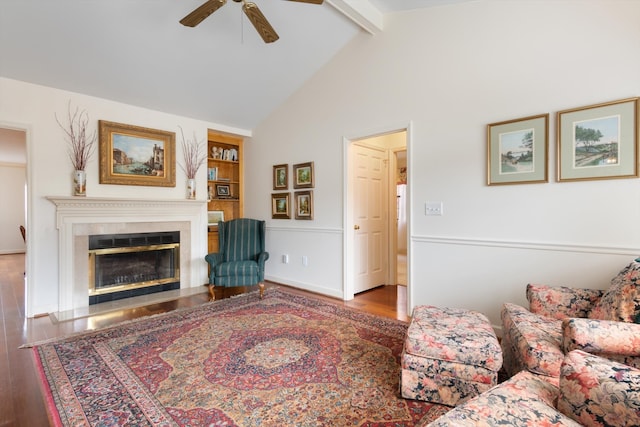 living room with ceiling fan, beam ceiling, dark wood-type flooring, and high vaulted ceiling