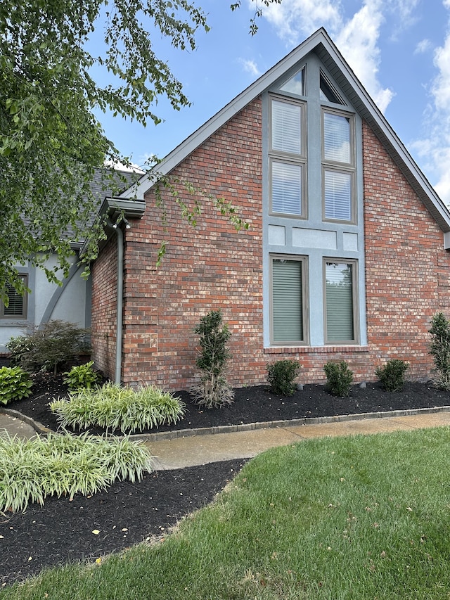 view of property exterior with a lawn