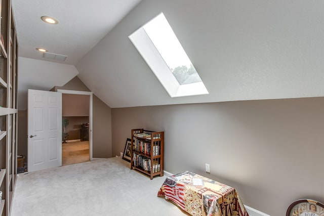 additional living space with vaulted ceiling with skylight and carpet