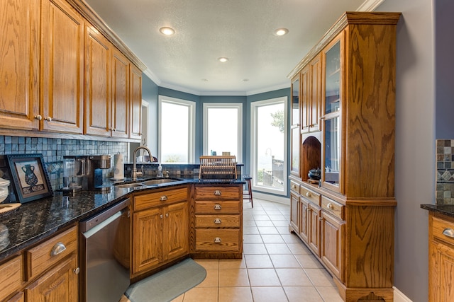 kitchen with dark stone countertops, backsplash, sink, and dishwasher