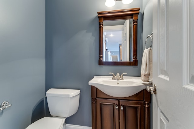 bathroom with vanity with extensive cabinet space and toilet