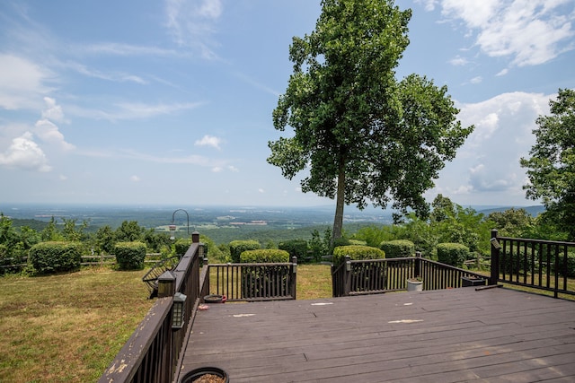 wooden deck featuring a lawn