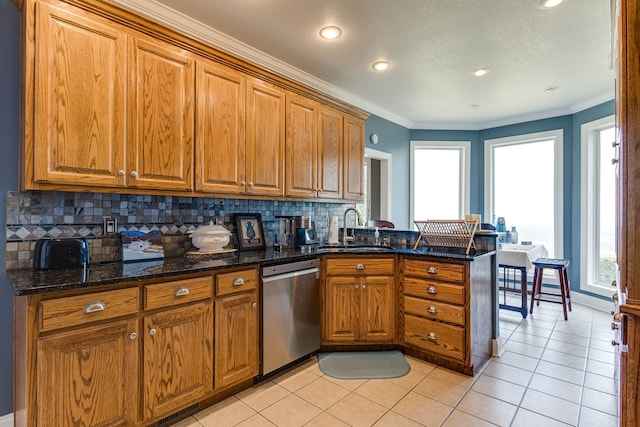 kitchen with sink, dark stone countertops, light tile floors, stainless steel dishwasher, and tasteful backsplash