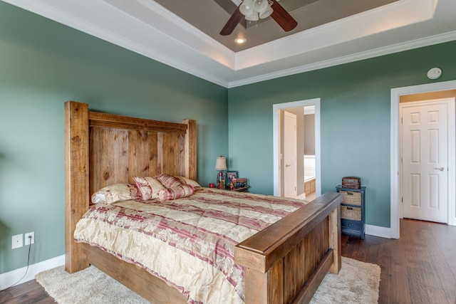 bedroom featuring a tray ceiling, ceiling fan, and dark wood-type flooring