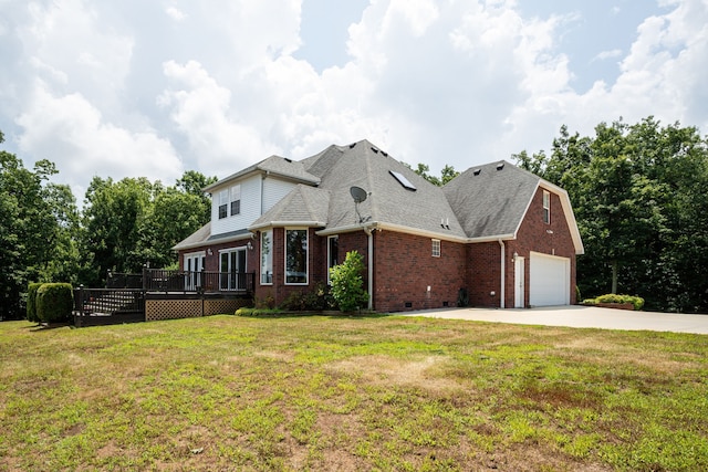 view of front of property with a wooden deck, a front yard, and a garage