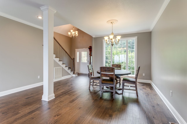 dining space featuring an inviting chandelier, decorative columns, dark hardwood / wood-style flooring, and ornamental molding