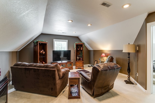 carpeted living room featuring vaulted ceiling and a textured ceiling