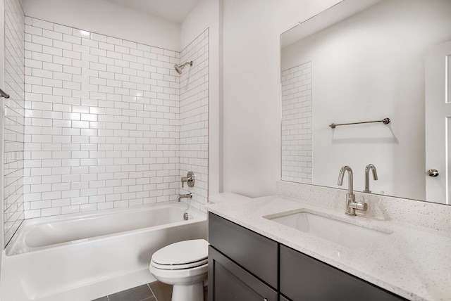 full bathroom with toilet, vanity, tile flooring, and tiled shower / bath