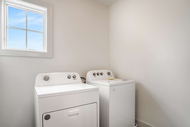 clothes washing area with separate washer and dryer