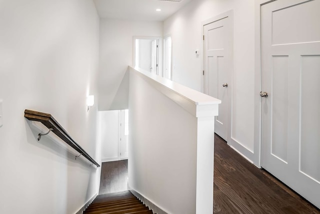 staircase with dark wood-type flooring