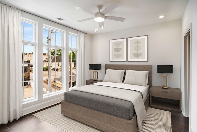 bedroom with ceiling fan and dark wood-type flooring