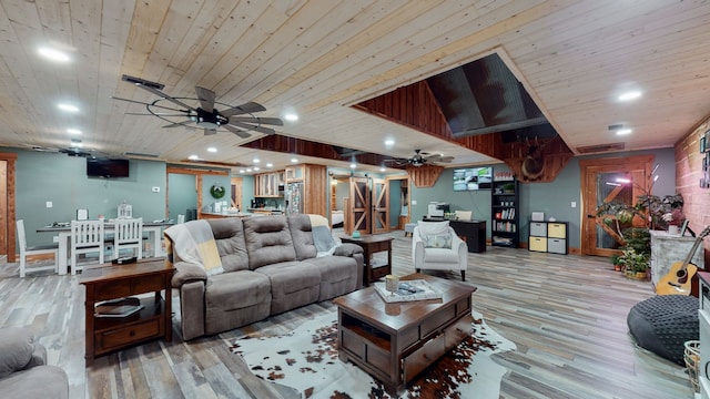 living room featuring wood ceiling, ceiling fan, and light wood-type flooring