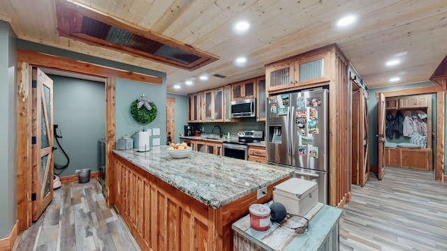 kitchen featuring stainless steel appliances, wooden ceiling, light hardwood / wood-style flooring, light stone counters, and sink