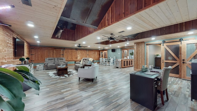 living room with a barn door, ceiling fan, wooden ceiling, and light hardwood / wood-style flooring