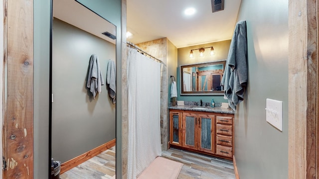 bathroom featuring vanity and wood-type flooring