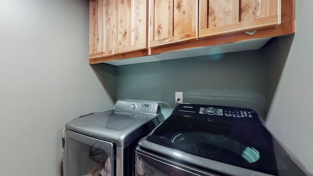 laundry room with cabinets and separate washer and dryer