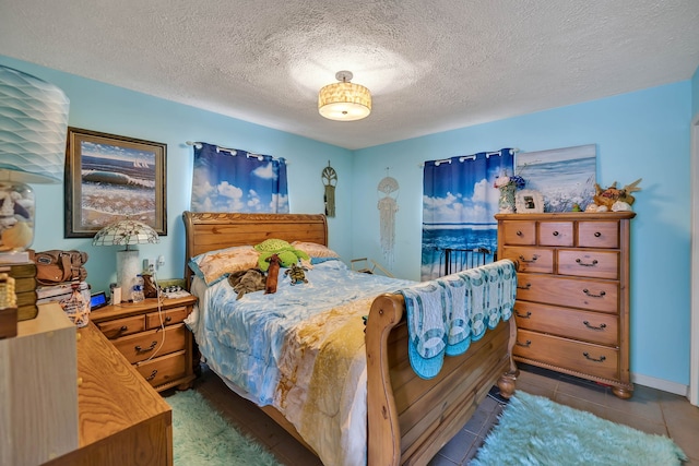 tiled bedroom with a textured ceiling