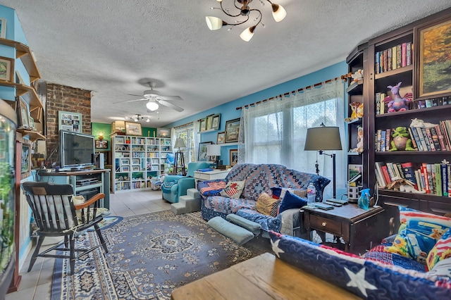 tiled living room with ceiling fan, brick wall, and a textured ceiling