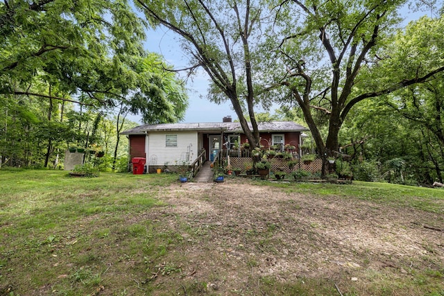 back of property with a deck and a lawn