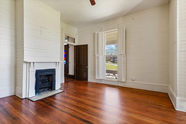 unfurnished living room featuring wood-type flooring and ceiling fan