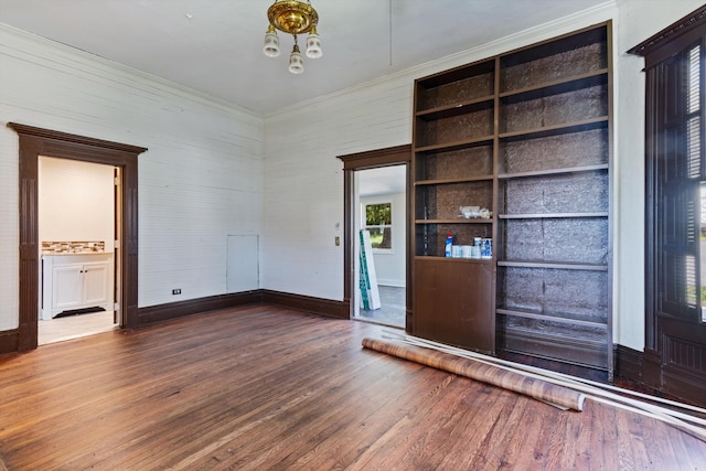 interior space with built in shelves and dark wood-type flooring