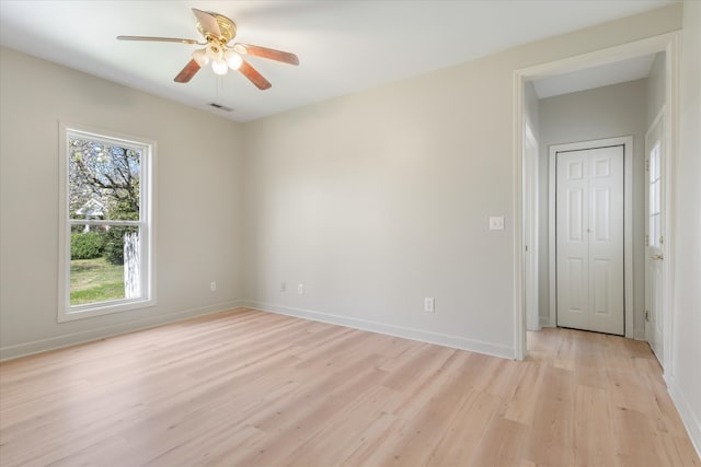 spare room featuring light wood-type flooring and ceiling fan