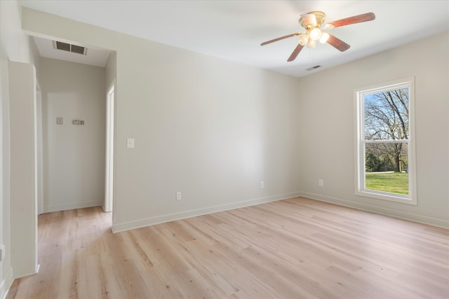 spare room with a wealth of natural light, light hardwood / wood-style flooring, and ceiling fan