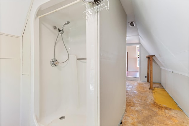 bathroom featuring a shower and lofted ceiling