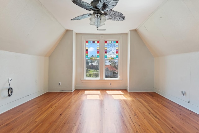 additional living space with ceiling fan, light hardwood / wood-style floors, and vaulted ceiling