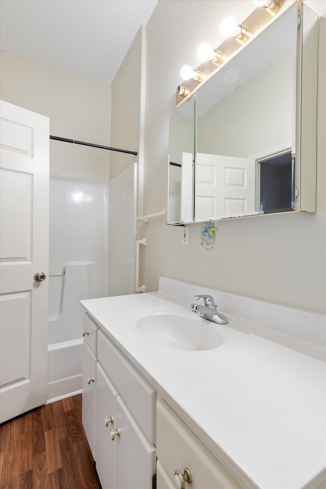 bathroom featuring vanity, tub / shower combination, and hardwood / wood-style flooring