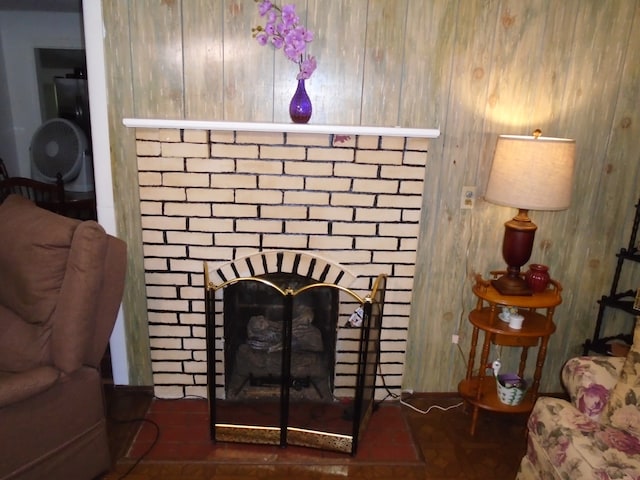 interior space featuring wooden walls and a brick fireplace