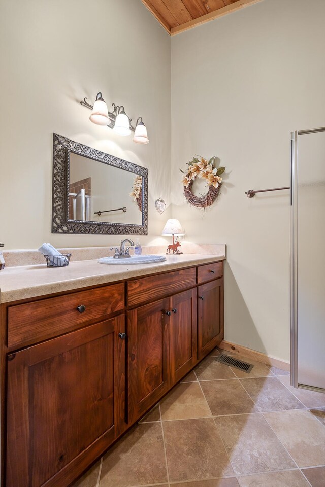 bathroom featuring baseboards, visible vents, and vanity